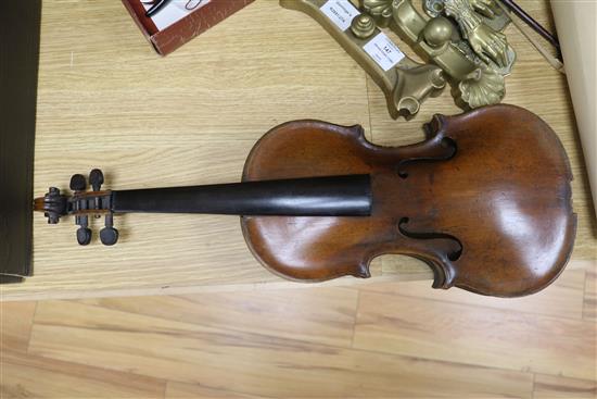 A violin, bow and a mother of pearl inlaid mandolin